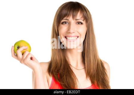 Lächelnde Mädchen hält grünen Apfel in der hand. Fitness-Frau isoliert auf weißem Hintergrund Stockfoto