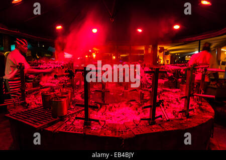 Köche, die verschiedene Arten von Fleisch auf einem großen Restaurant Grill Grillen. Stockfoto