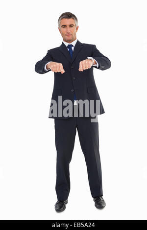 Lächelnde Geschäftsmann im Anzug gestikulieren Stockfoto