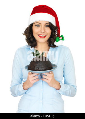 Junge Frau in einem Weihnachten Santa Hut Holding traditionelle Weihnachtspudding Stockfoto