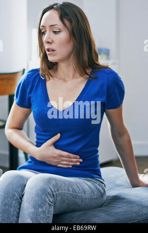 FRAU MIT SCHMERZEN IM UNTERLEIB Stockfoto