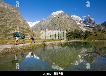 Seitenmoräne auf der Seite der schnell sich zurückziehenden Gletscher de Miage unten Mont Blanc, Italien, mit Wanderer tun die Tour du Mont-Blanc. Stockfoto