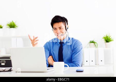 lächelnde Geschäftsmann tragen ein Kopfhörer im Büro Stockfoto