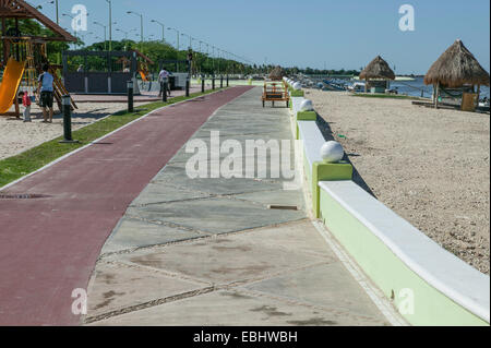 Blick entlang der Laufstrecke, Spielplatz, Bürgersteig, Strand, Palapas und Bucht, Campeche, Mexiko zeigt Melecon. Stockfoto