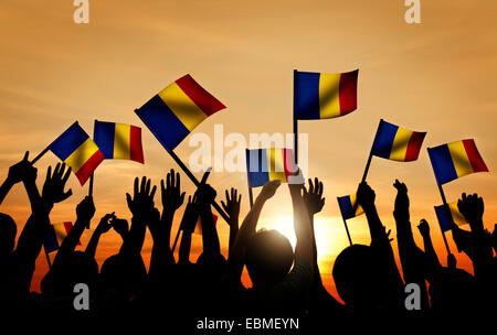 Gruppe von Menschen, die winken rumänische Flaggen im Gegenlicht Stockfoto