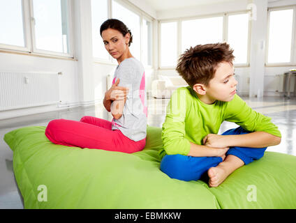 Junge Frau und Sohn aufregen, sitzen auf einem Sitzsack in einem Loft, Deutschland Stockfoto