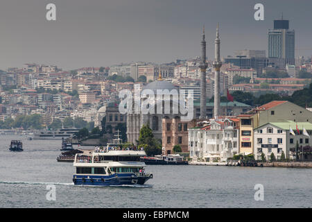 Ortakoy Mecidiye Moschee und Personenfähre, Ortakoy, vom Bosporus mit Skyline von Istanbul hinter, Istanbul, Türkei Stockfoto