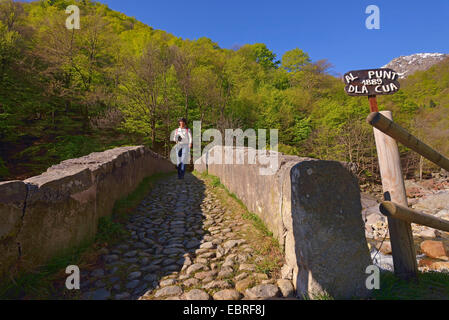 weibliche Wanderer auf Steinbrücke, Italien, Piedicavallo Stockfoto