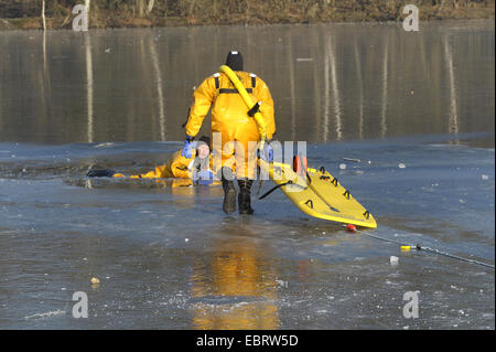 Firefighers üben Rettung auf zugefrorenen See, Deutschland Stockfoto