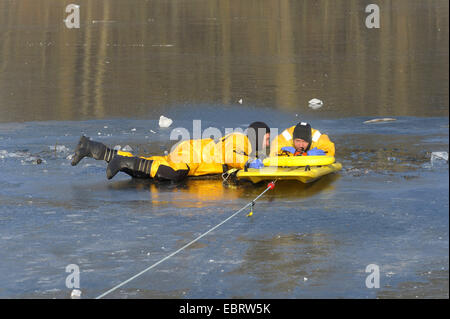 Firefighers üben Rettung auf zugefrorenen See, Deutschland Stockfoto