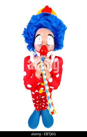 kleine Clown weht in einer Partei-horn Stockfoto