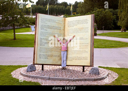 Mädchen in einem überdimensionalen Buch in Astrid Lindgren Vaerld, Astrid Lindgren World, Schweden, Smaland, Vimmerby Stockfoto