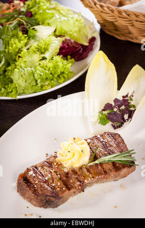 Gesunde Platte mit gemischtem Fleisch einschließlich gegrilltes Steak, knusprig Panierter Hühner- und Rindfleisch auf einem Bett aus frischen grünen grünen gemischten sa Stockfoto