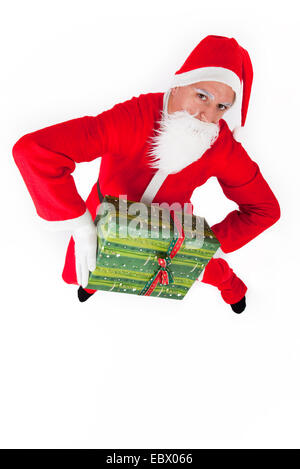 Santa Claus mit Weihnachtsgeschenk Stockfoto