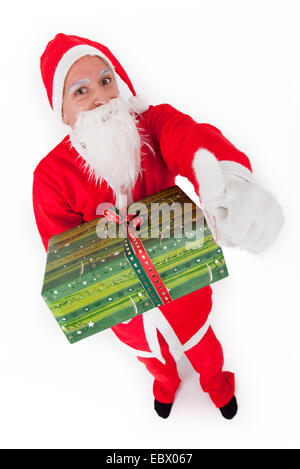 Santa Claus mit Weihnachtsgeschenk Stockfoto
