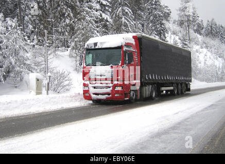 LKW auf einer verschneiten Straße Stockfoto