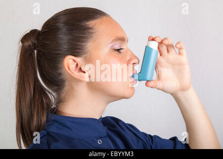 Süße Krankenschwester mit Asthma-Inhalator Stockfoto