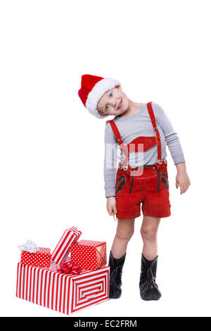 Konzept: Weihnachten in der Kindheit. Kid im roten Kostüm Zwerg mit Geschenken. Studioportrait isoliert auf weißem Hintergrund Stockfoto