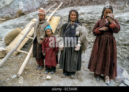 Ladakh.  4 lokale Dorfbewohner, alle in der traditionellen Kleidung, stehen an der Kreuzung der drei Flüsse verbinden. Holzleiter, Stockfoto