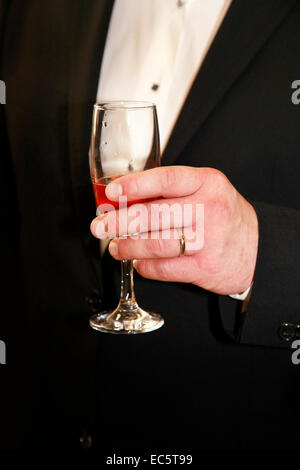 Glas Sekt in der Hand des Bräutigams Stockfoto