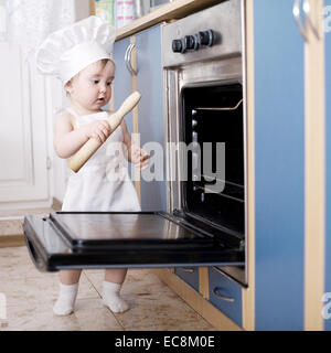 Baby-Chef kocht im Ofen Essen Stockfoto