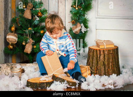 Kleiner Junge hält sein Weihnachtsgeschenk Stockfoto