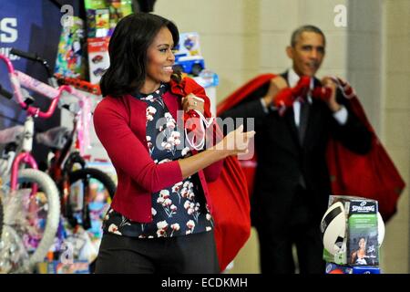 US-Präsidentengattin Michelle Obama kommt mit Präsident Barack Obama und Taschen von Weihnachten Spielzeug während des Marine Corps Spielwaren für Tots Kampagne am Joint Base Anacostia-Bolling 10. Dezember 2014 in Washington, DC. Stockfoto