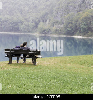 Liebhaber auf der Bank vor dem See Stockfoto