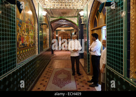 Indische Restaurantmitarbeiter stehen am Eingang eines iranischen Restaurants im Souq Waqif-Markt im Stadtteil Al Souq im Zentrum der Hauptstadt Doha von Katar Stockfoto