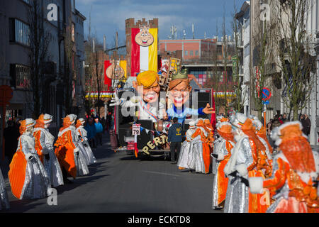 Karikaturen auf einem Karneval-Schwimmer und bunt kostümierten Figuren in Aalst Karnevalszug, Karneval Montag, Aalst, Belgien Stockfoto