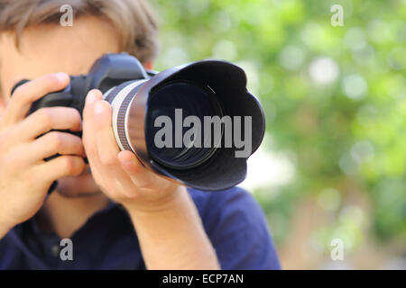 Nahaufnahme eines Fotografen mit einer Dslr-Kamera mit einem grünen Hintergrund Stockfoto