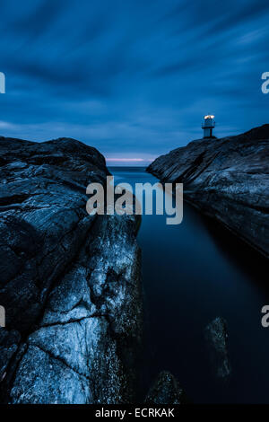 Leuchtturm und einem felsigen Ufer in der Nacht Stockfoto