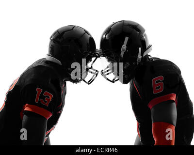 zwei american-Football-Spieler von Angesicht zu Angesicht in Silhouette Schatten auf weißem Hintergrund Stockfoto