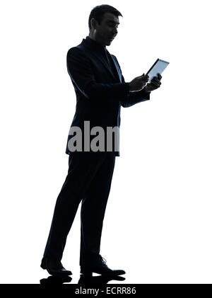 ein Business-Mann überrascht mit digital-Tablette in Silhouette auf weißem Hintergrund Stockfoto