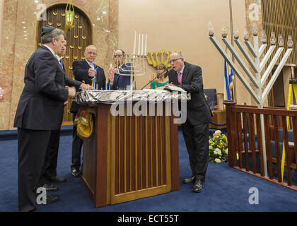 Merrick, New York, USA. 18. Dezember 2014. L-R, Nassau County Executive ED MANGANO, New York Senator Elect MICHAEL VENDITTO, Assemblyman DAVE McDONOUGH, Assistant Rabbi RAVID TILLES und zwei andere beteiligen sich an die feierliche Kerze Beleuchtung auf der Bema in das wichtigste Heiligtum des jüdischen Zentrums Merrick, wenn es versucht, den Guinness Weltrekord für die meisten Menorot beleuchtet in einem Ort zur gleichen Zeit zurückzugewinnen, die die Gemeinde im Jahr 2011 statt. In der dritten Nacht von Hanukkah enthalten die "Light Up the Night 2 - bringt die Rekord-Haus" Veranstaltung auch Dudelsackspieler. Obwohl die Menorah-Beleuchtung-Ziel Stockfoto