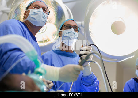 Niedrigen Winkel Blick auf zwei Chirurgen halten Laparoskopie Ausrüstung im Operationssaal Stockfoto