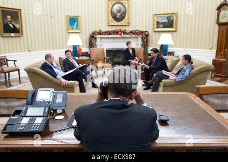 US-Präsident Barack Obama spricht mit kubanischer Präsident Raul Castro am Telefon als seine Staatssicherheit Berater treffen im Oval Office des weißen Hauses 16. Dezember 2014 in Washington, DC. Obama vereinbart, diplomatische Beziehungen zu Kuba nach 50 Jahren wieder herzustellen. Stockfoto