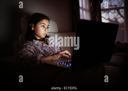 Gemischte Rassen Mädchen mit Laptop in der Nacht Stockfoto