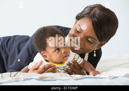 Mutter mit Sohn im Bett spielen Stockfoto