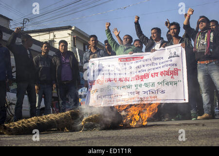 Sivasagar, Assam, Indien. 24. Dezember 2014. Indien, SIVASAGAR: Aktivisten der Asom Jatiyatabadi Yuba Charta Parishad (AJYCP) brennen das Bildnis von Assam Ministerpräsident Tarun Gogoi aus Protest gegen Angriffe auf die Dorfbewohner von militanten an vier verschiedenen Orten im Sivasagar Viertel der nordöstliche Assam Zustand am 24. Dezember 2014. Stockfoto