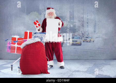 Zusammengesetztes Bild von Santa, die Geschenke aus dem Warenkorb zu liefern Stockfoto
