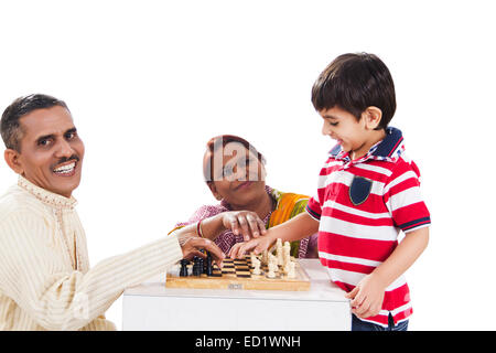 indische Eltern und Enkel spielen Schachbrett Stockfoto
