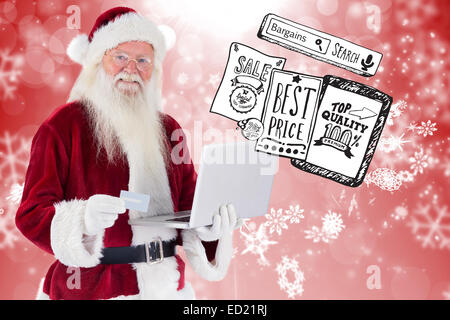 Zusammengesetztes Bild von Santa zahlt mit Kreditkarte auf einem laptop Stockfoto