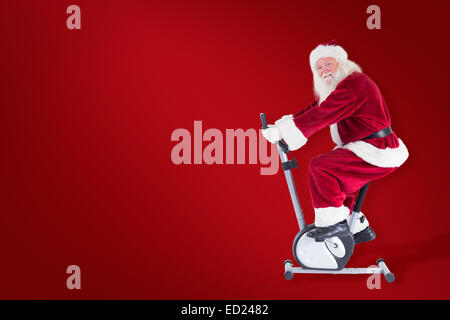 Zusammengesetztes Bild von Santa nutzt ein Hometrainer Stockfoto