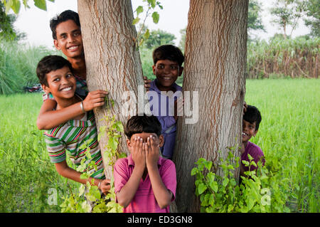 indische ländlichen Gruppe Streichelzoo spielen Hide and Seek Stockfoto