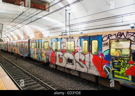 Bunte Graffiti auf den Seiten der Wagen betrachtet ein u-Bahn-Zug parkten in einer u-Bahnstation über die Strecke Stockfoto