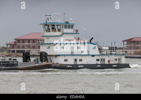 Schlepper und Barge in Galveston Hafenkanal Küstenwachstation vorbei. Stockfoto