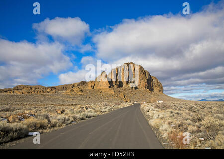 Eine einsame Straße am Fort Rock Naturschutzgebiet, ist eine vulkanische Hebung in der Wüste von Oregon Outback, Zentral-Oregon. Stockfoto