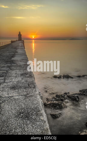 Die Sonnenaufgänge über Herm, Castle Cornet Pause Wasser entnommen, St Peter Port, Guernsey Kanalinseln Stockfoto