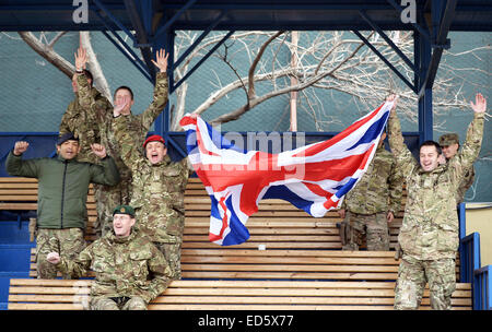 Kabul, Afghanistan. 24. Dezember 2014. Britische Soldaten jubeln nach dem 3: 0-Sieg ihrer Mannschaft in einem Fußballspiel gegen deutsche auf der umgestalteten Heliport des ISAF-Hauptquartiers in Kabul, Afghanistan, 24. Dezember 2014 Soldaten. Anlässlich des 100. Jahrestages der "Christmas Truce" bei deutschen, britischen und französischen Soldaten ihre Waffen in den Schützengräben Flanderns in 1914 einige Fußball spielen initiiert die deutschen und britischen Soldaten in Kabul das Spiel. Foto: Subel Bhandari/Dpa/Alamy Live News Stockfoto